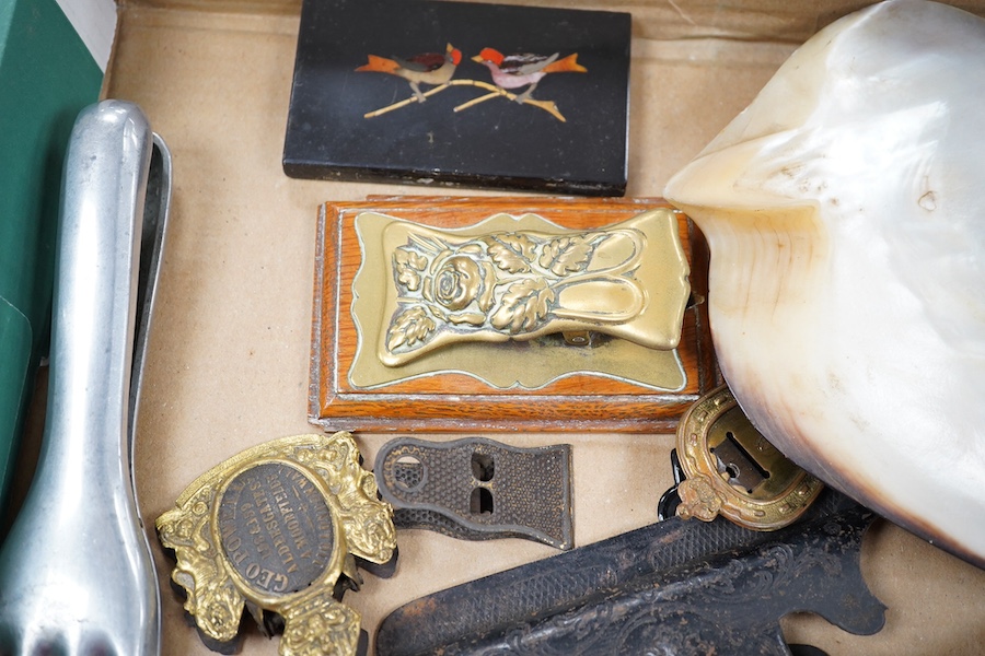 A collection of novelty hand and other desk paper clips, including a large mother of pearl shell, a pietra dura plaque and a brass pen stand, 22cm high. Condition - one poor but mostly fair to good